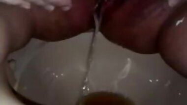 Closeup of Jen Pissing in the Porta Potti