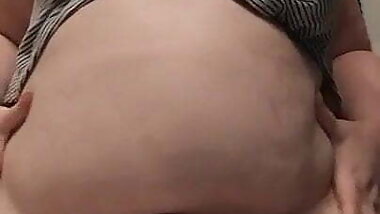 Librarian shows off big fat belly and jiggles it.