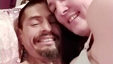 Sexy wife and husband relaxing on the bed