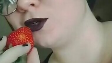 sucking on a strawberry
